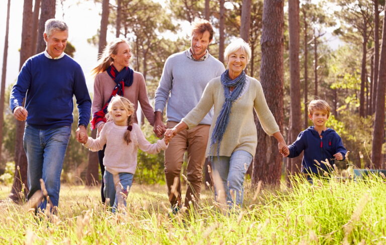 Happy multigenerational family walking in the woods