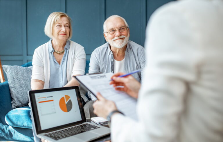 Relaxed senior couple talking to a financial planner