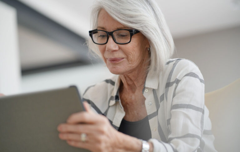 A senior woman looking at her tablet
