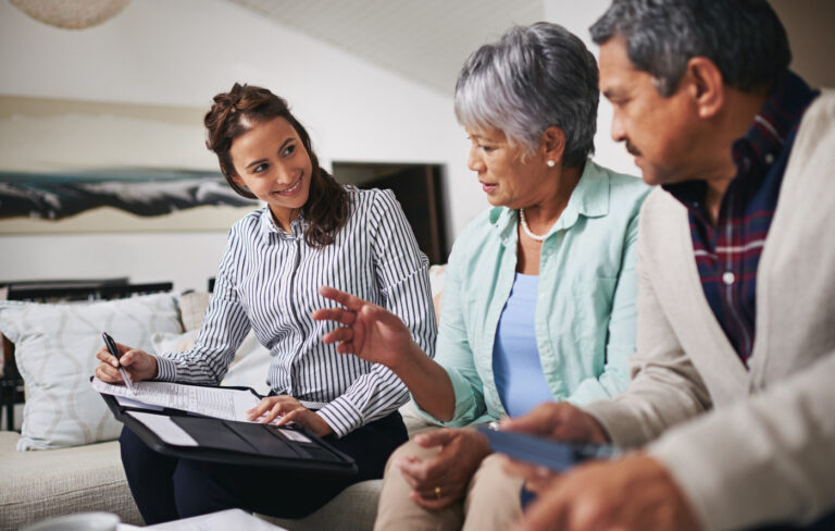 Affluent senior couple talking to a female financial planner